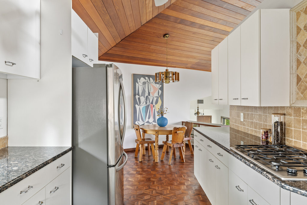1922 Cypress Point West Austin, TX 78746 - Photo 18 of 38 a kitchen with stainless steel appliances granite countertop a refrigerator and a stove top oven