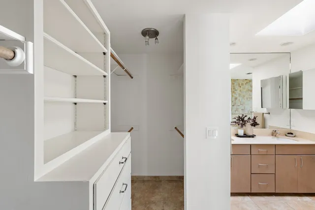 a bathroom with a bathtub sink vanity and mirror