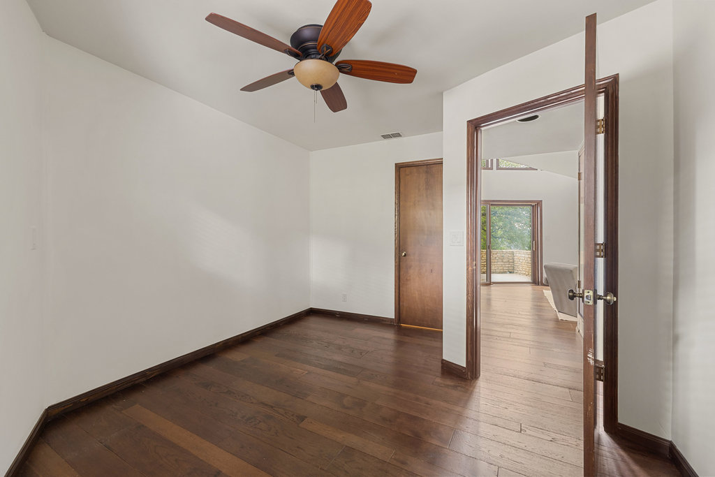 1922 Cypress Point West Austin, TX 78746 - Photo 29 of 38 a view of empty room with wooden floor and fan