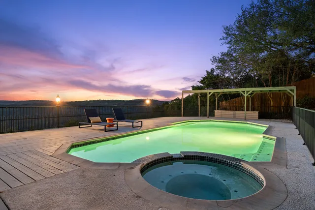a view of a swimming pool with a yard
