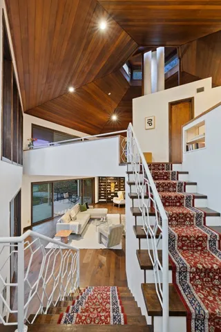 a bed room with lots of furniture and a chandelier