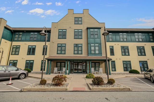a front view of a residential apartment building with a yard