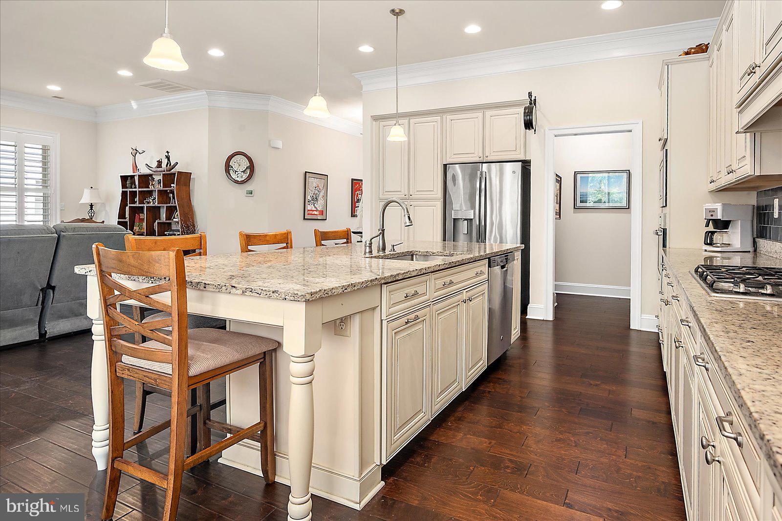 30561 Silverton Road Frankford, DE 19945 - Photo 21 of 60 a kitchen with stainless steel appliances kitchen island granite countertop a kitchen island and chairs in it