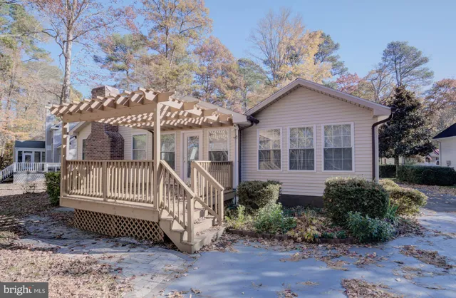 a kitchen with stainless steel appliances granite countertop a refrigerator a stove a sink and white cabinets with wooden floor