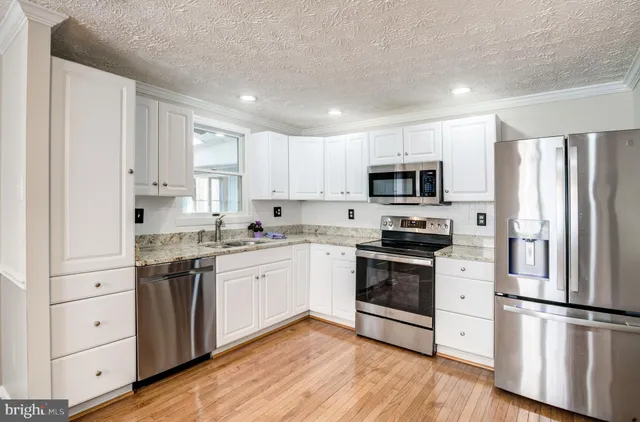 a living room with furniture a mirror and a lamp