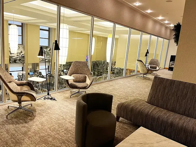 a living room with furniture and large windows