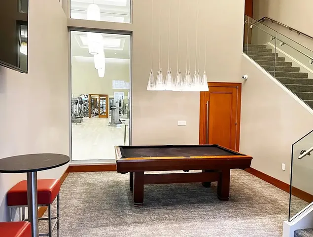 a room with pool table and windows