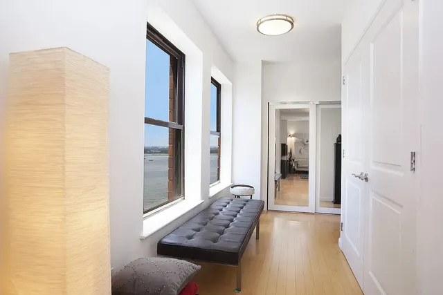 a view of a hallway and a livingroom with furniture