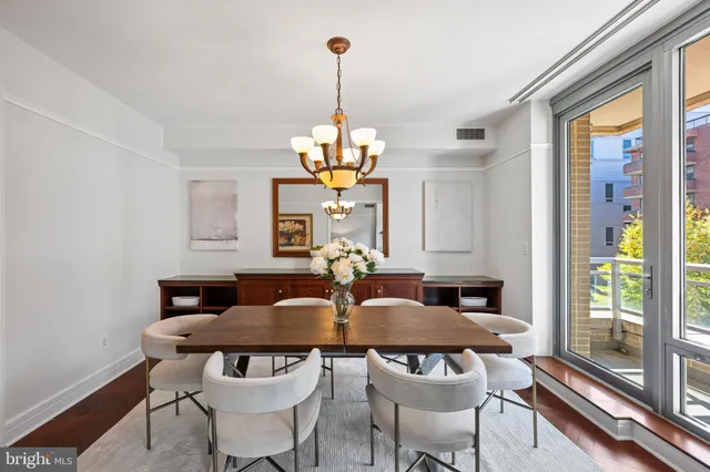 a view of a dining room with furniture wooden floor and chandelier