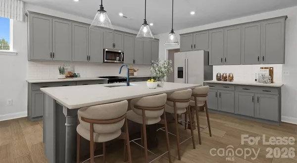 a kitchen with a dining table chairs sink and microwave