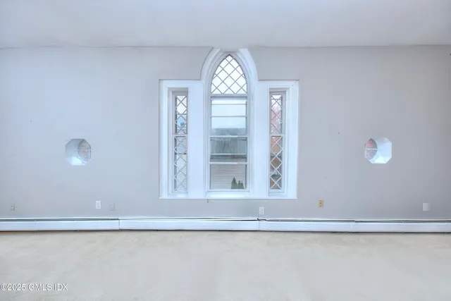 a view of an empty room and fire place