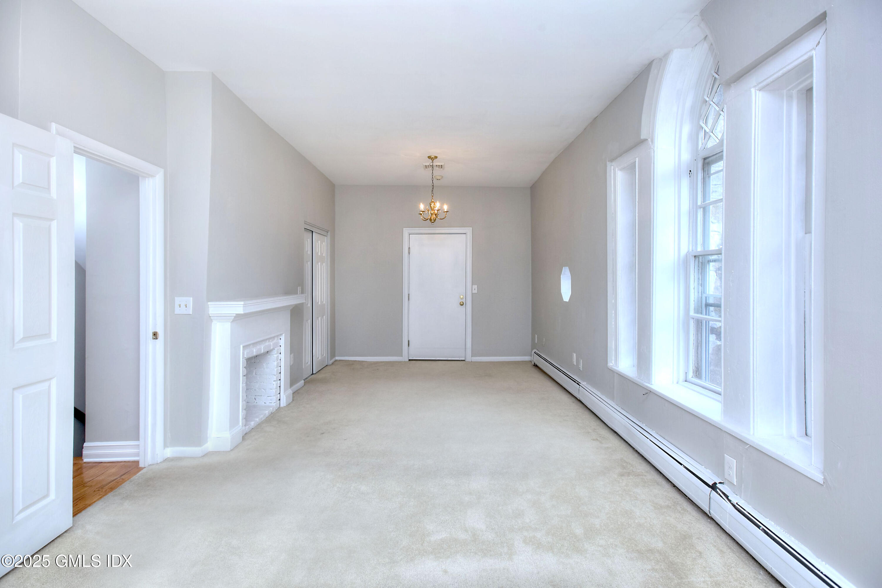 300 Soundview Avenue, Unit DUPLEX Fairfield, CT 06825 - Photo 20 of 27 an empty room with windows and pillars in it