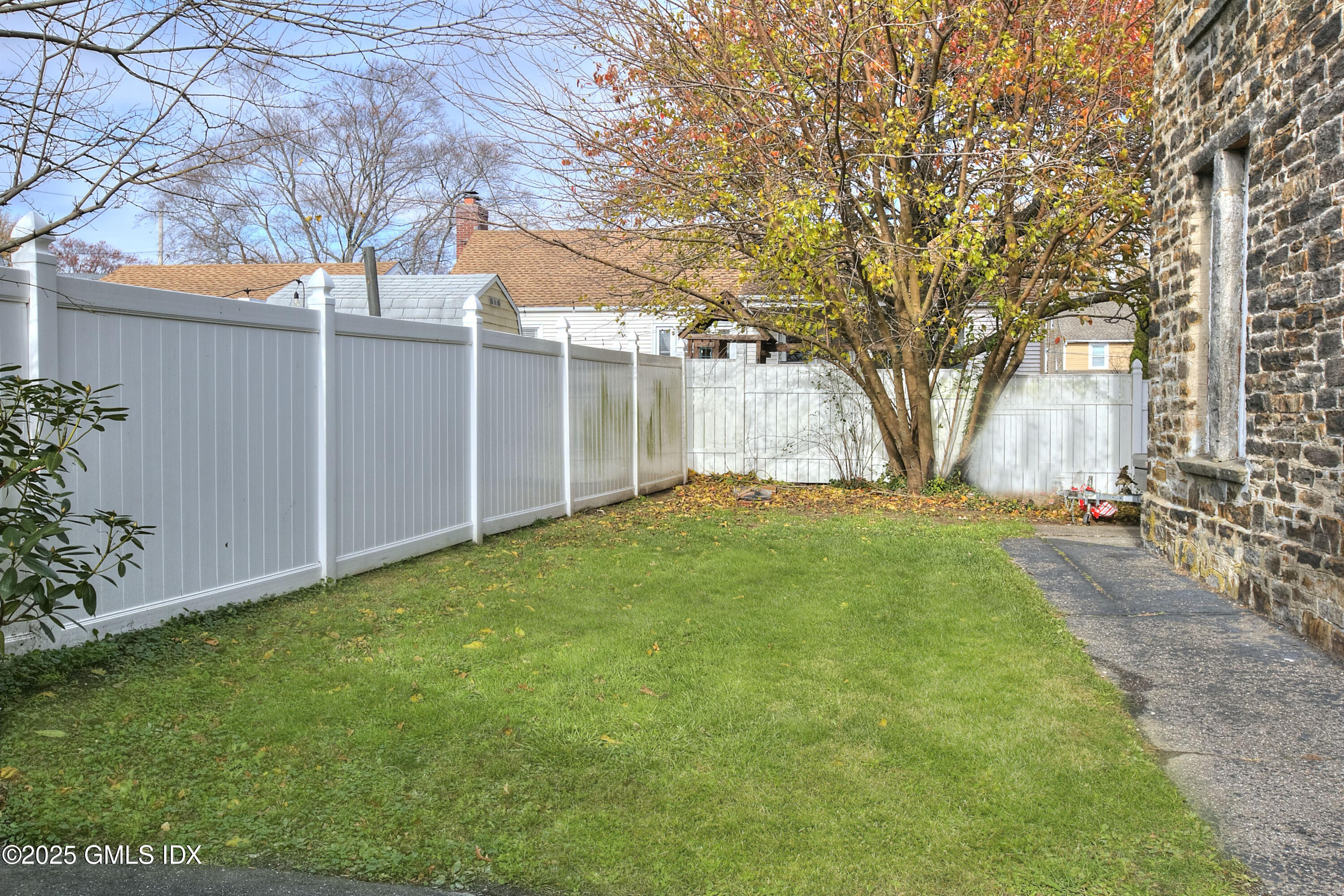 300 Soundview Avenue, Unit DUPLEX Fairfield, CT 06825 - Photo 3 of 27 a view of a backyard with large trees