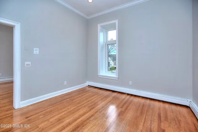 a kitchen with stainless steel appliances granite countertop a stove top oven a refrigerator a sink dishwasher and cabinets with wooden floor