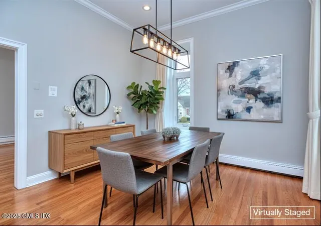 a kitchen with stainless steel appliances granite countertop a stove a sink and a refrigerator with wooden floors