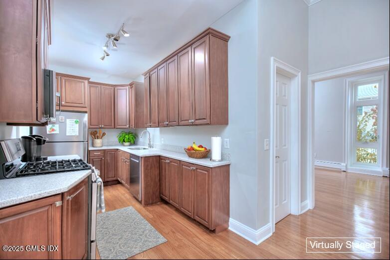 300 Soundview Avenue, Unit DUPLEX Fairfield, CT 06825 - Photo 10 of 27 a kitchen with stainless steel appliances granite countertop a stove top oven a refrigerator a sink dishwasher and cabinets with wooden floor