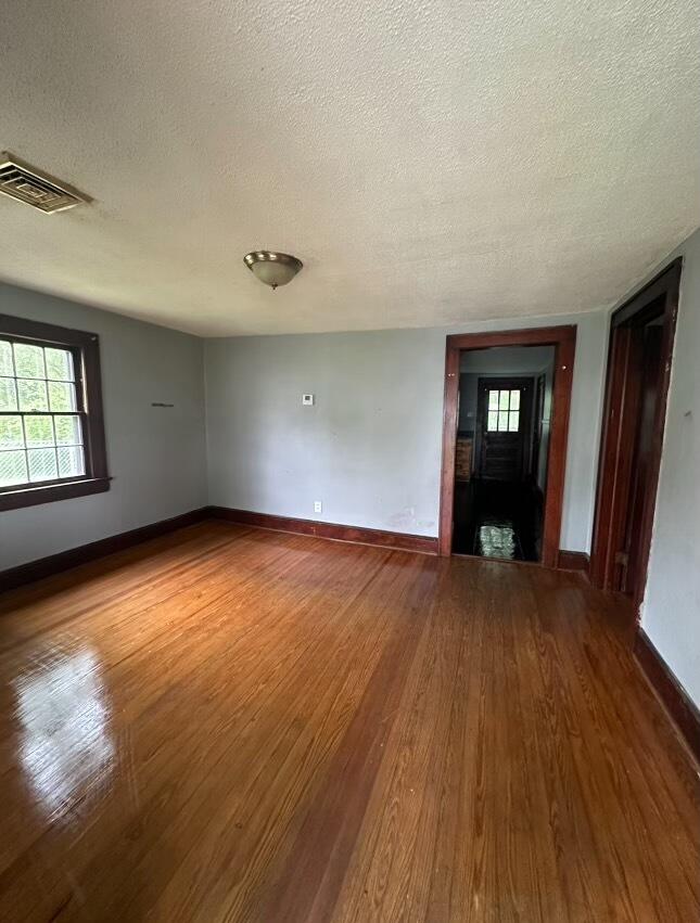 1815 Riverdale Road Southeast Roanoke, VA 24014 - Photo 10 of 10 an empty room with wooden floor and windows