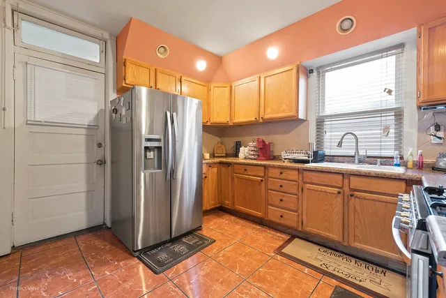 a kitchen with stainless steel appliances granite countertop a refrigerator and a sink