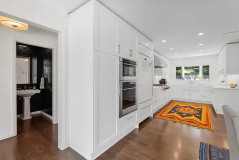 a view of a kitchen with a sink and a refrigerator