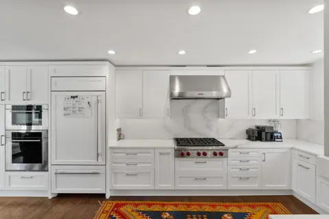 a kitchen with refrigerator and cabinets