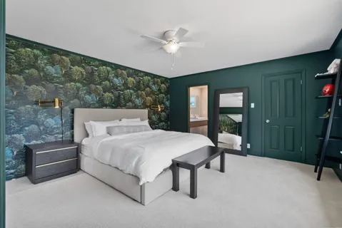 a spacious bedroom with a bed and a large window
