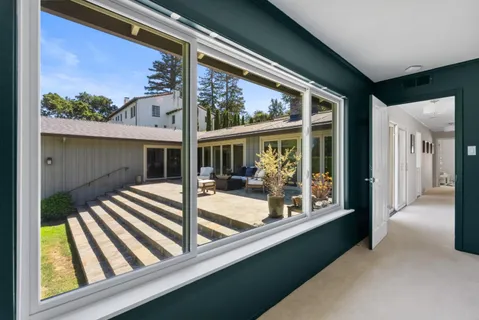 a view of house with a large window and wooden floor