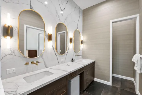 a bathroom with a double vanity sink and a mirror