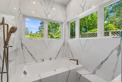 a bath tub sitting in a bathroom next to a window