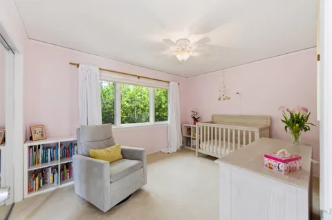 a bedroom with furniture and a book shelf
