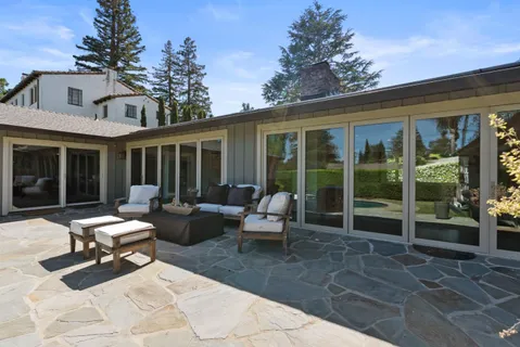 a building outdoor space with patio furniture and garden