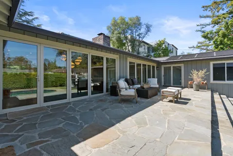 a building outdoor space with patio furniture and garden