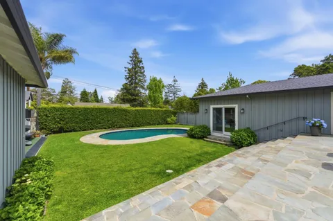 a view of a wooden house with a yard