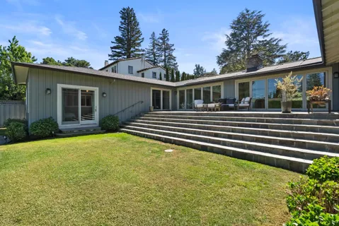 a front view of a house with a garden
