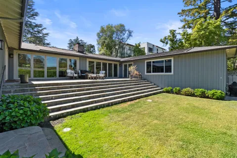 a view of a house with a backyard