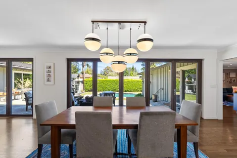 a view of a dining room with furniture wooden floor and chandelier