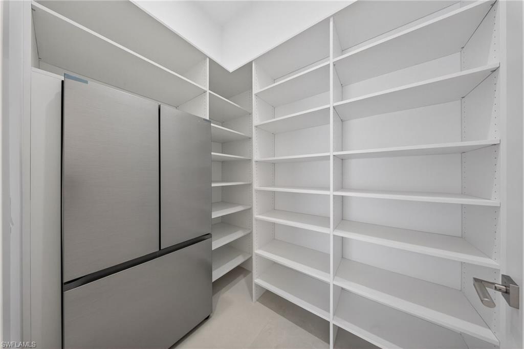 1874 39th Street Southwest Naples, FL 34117 - Photo 16 of 50 a view of walk in closet with empty racks