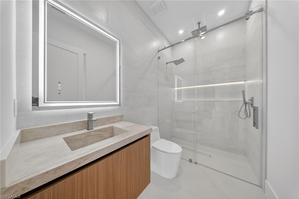 1874 39th Street Southwest Naples, FL 34117 - Photo 26 of 50 a bathroom with a sink a toilet and shower