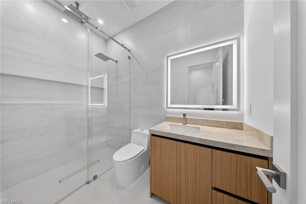 1874 39th Street Southwest Naples, FL 34117 - Photo 30 of 50 a bathroom with a sink and a mirror