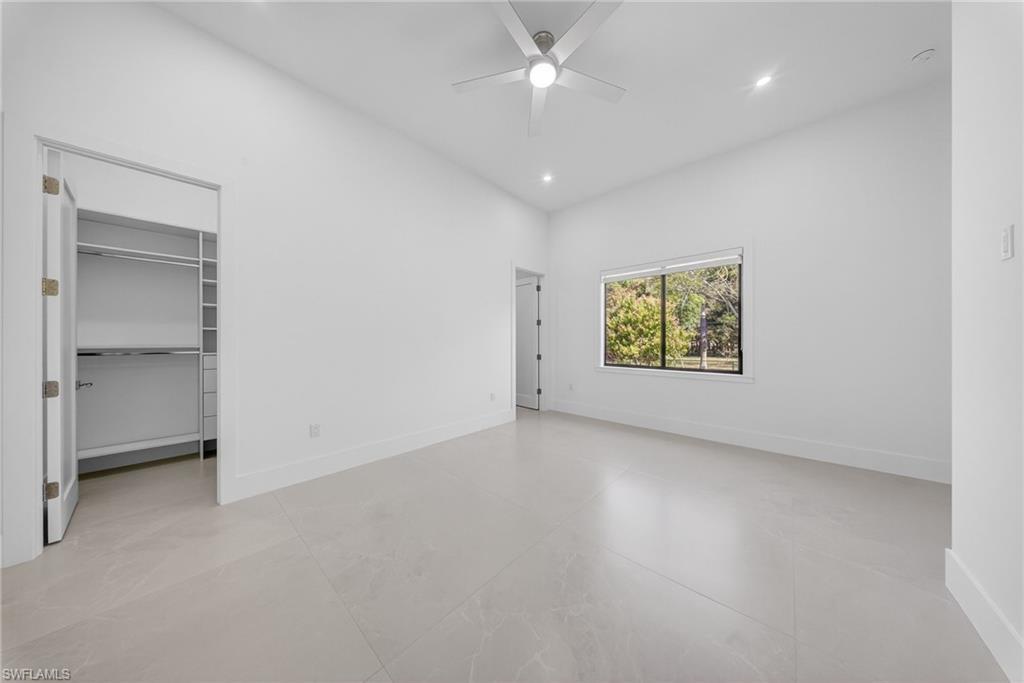 1874 39th Street Southwest Naples, FL 34117 - Photo 32 of 50 an empty room with a ceiling fan and a window