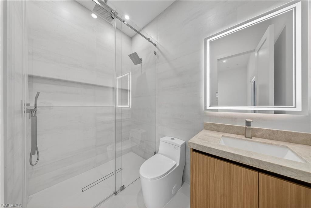 1874 39th Street Southwest Naples, FL 34117 - Photo 34 of 50 a bathroom with a granite countertop sink toilet and shower