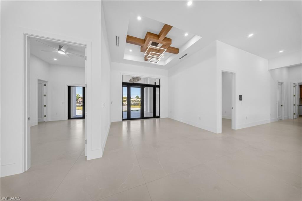 1874 39th Street Southwest Naples, FL 34117 - Photo 43 of 50 an empty room with windows and ceiling fan