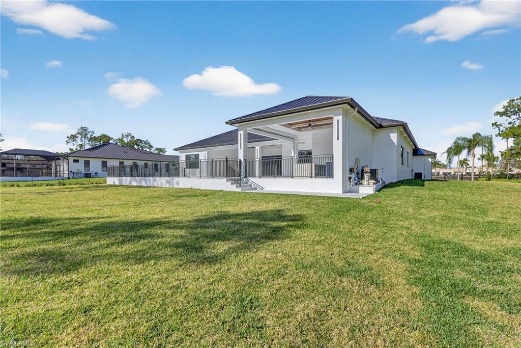 1874 39th Street Southwest Naples, FL 34117 - Photo 49 of 50 a view of a house with a big yard