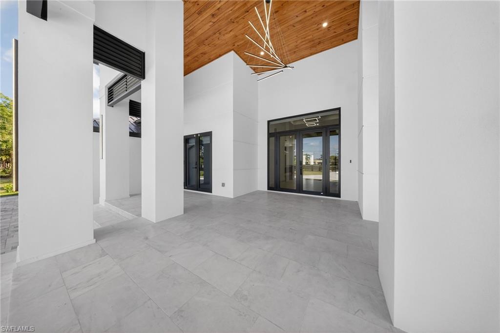 1874 39th Street Southwest Naples, FL 34117 - Photo 9 of 50 a view of an empty room with a fireplace and painted walls