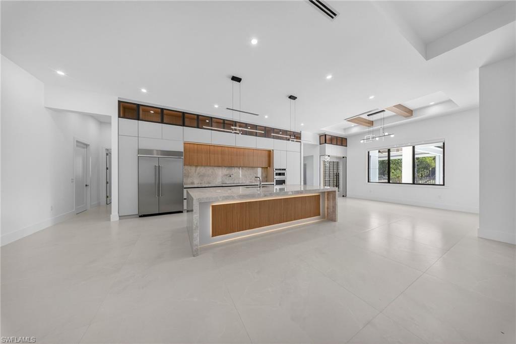 1874 39th Street Southwest Naples, FL 34117 - Photo 50 of 50 a large kitchen with stainless steel appliances a large counter top and a refrigerator
