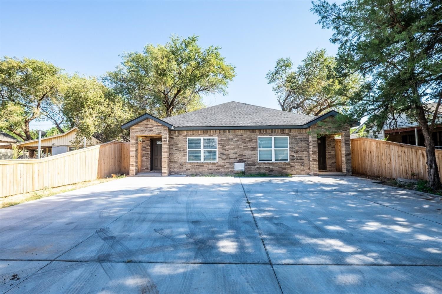 2311 20th Street Lubbock, TX 79411 - Photo 1 of 18 a front view of a house with a yard and garage