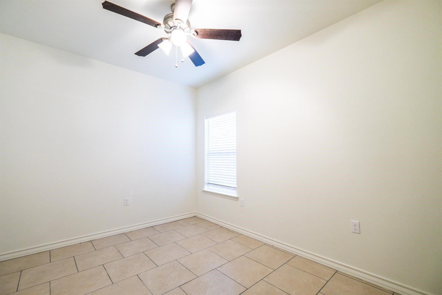 2311 20th Street Lubbock, TX 79411 - Photo 11 of 18 an empty room with windows and fan