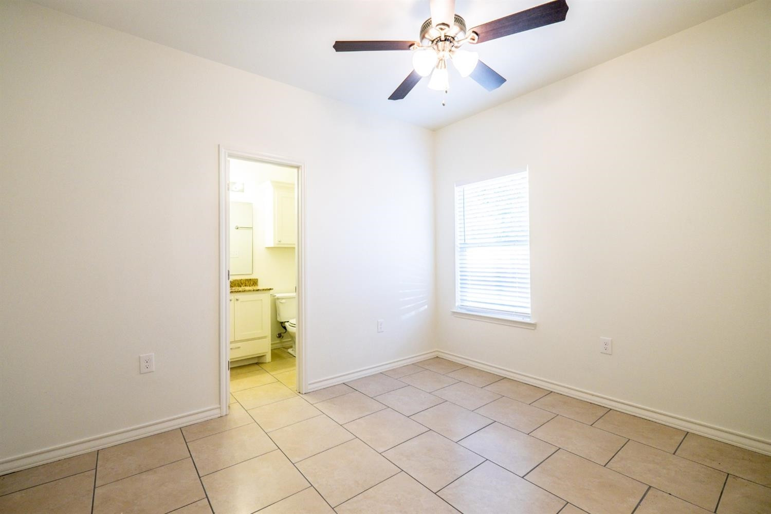 2311 20th Street Lubbock, TX 79411 - Photo 15 of 18 a view of an empty room with window and chandelier fan