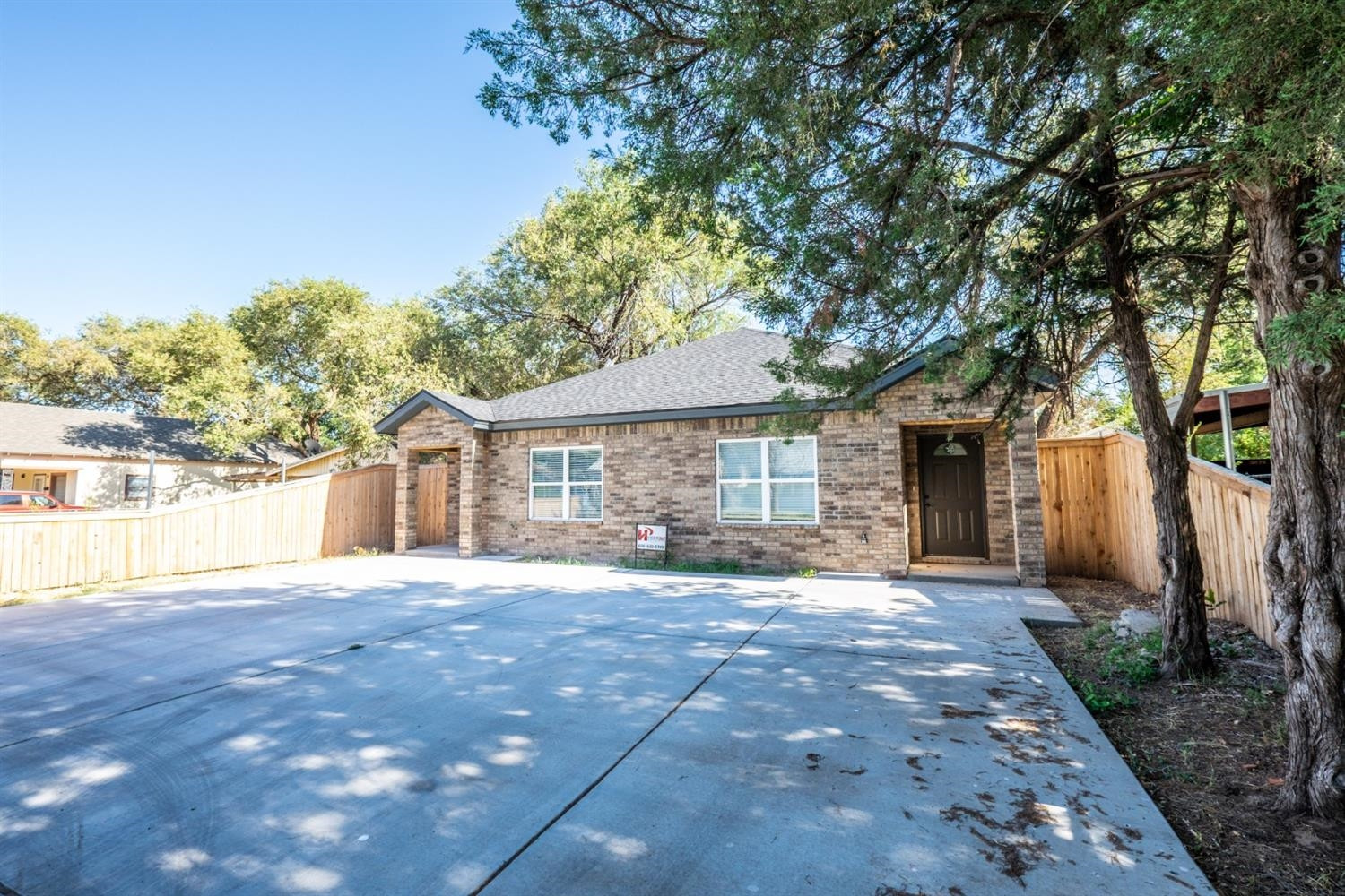 2311 20th Street Lubbock, TX 79411 - Photo 2 of 18 a front view of a house with a garden and trees
