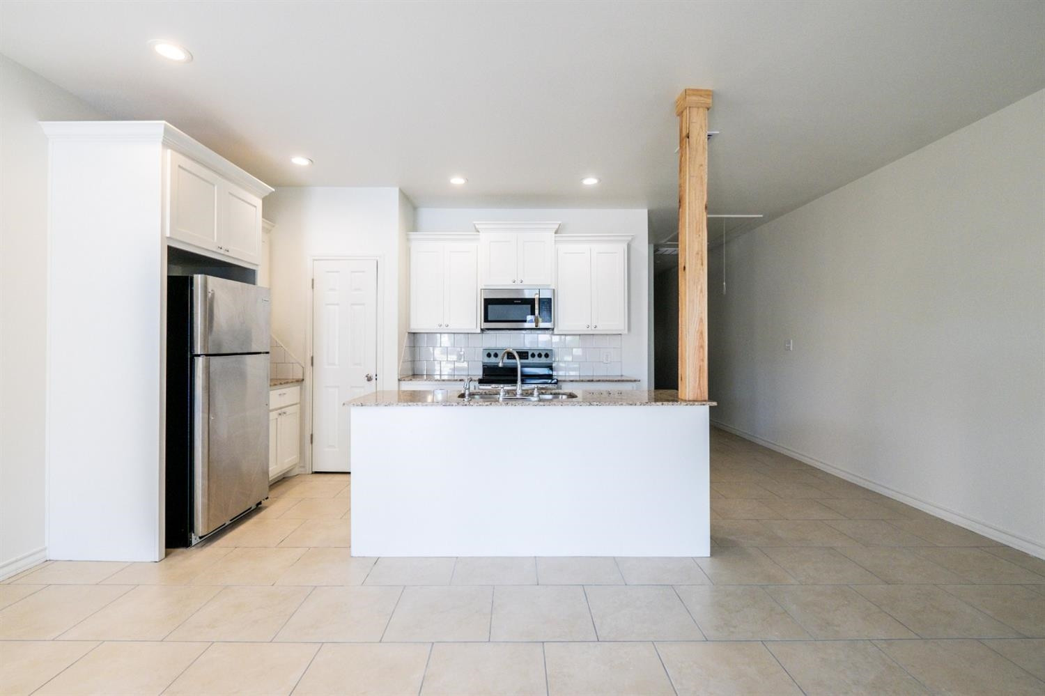 2311 20th Street Lubbock, TX 79411 - Photo 4 of 18 a view of kitchen with stainless steel appliances granite countertop a refrigerator a stove and a sink