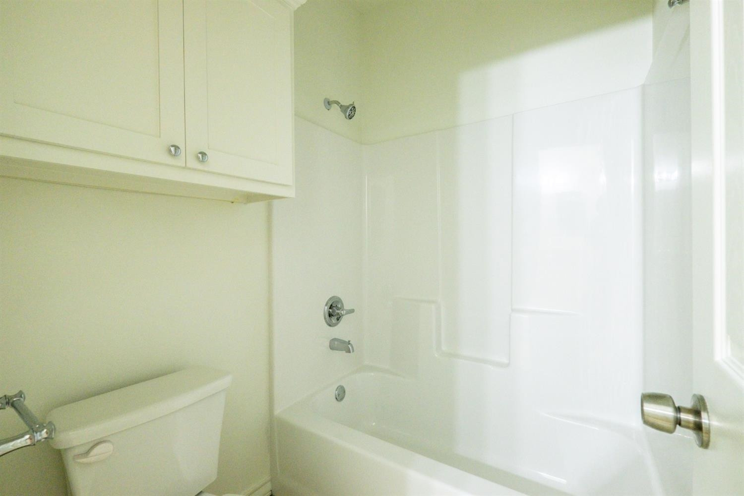 2311 20th Street Lubbock, TX 79411 - Photo 8 of 18 a white bath tub sitting next to a toilet